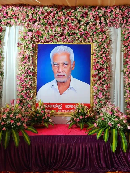 Another view of the memorial decoration, with a large floral frame around the portrait.