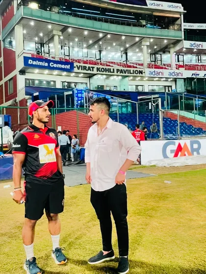 A conversation on the field. Discussing performance and strategy is an ongoing process.