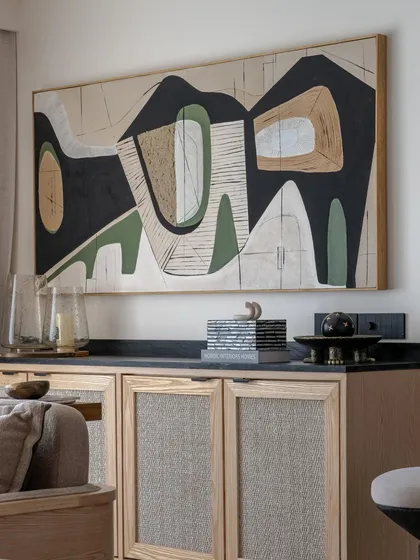 This large-scale abstract canvas was designed for a modern living space in Mumbai. The composition uses earthy tones, black, and white to create a sophisticated and balanced look that enhances the room's decor.