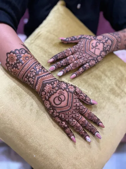 A clear view of the engagement design with interlocking rings and the initial 'K', set against a beautiful floral and geometric background.
