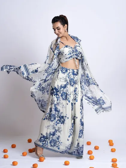 A full-length shot showing a breezy, floral co-ord set. The makeup is soft and romantic, with a focus on fresh skin to match the outfit's aesthetic.