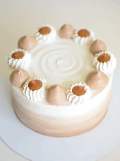 My Coffee & Caramel cake is a coffee lover's dream. It features layers of coffee-soaked cake, rich coffee ganache, and a smooth caramel filling, all frosted with a light coffee mousse.