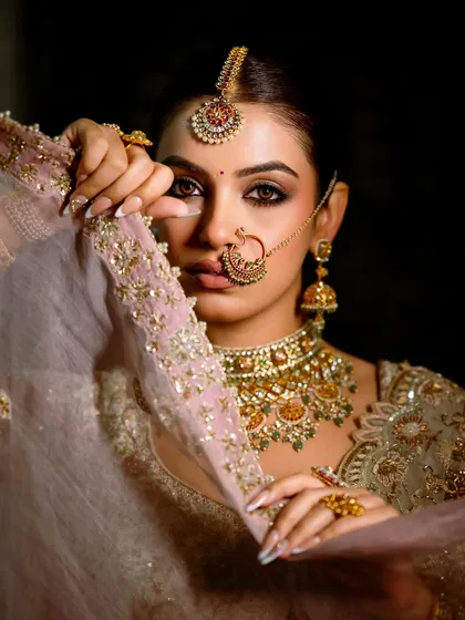 Another angle of this intense and dreamy look. The way she holds the veil adds a touch of mystery and drama to the overall aesthetic.