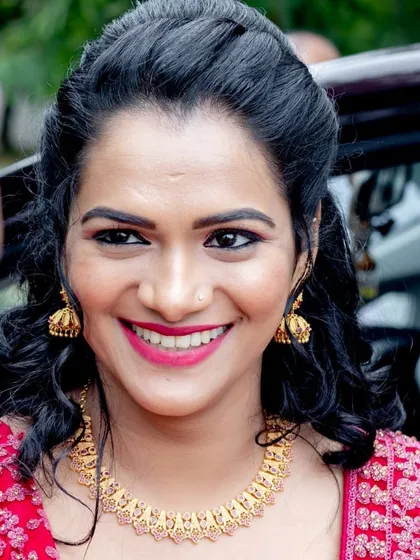 The pure joy of a happy client on her engagement day. This close-up shows a flawless, natural makeup look with a bold pink lip that perfectly captures her bright smile and excitement.