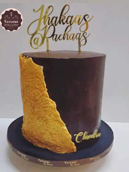 A "Jhakaas @ Pachaas" (Awesome at 50) cake for a 50th birthday. This is a 4 kg gooey chocolate truffle cake with a modern, textured gold fault line design.