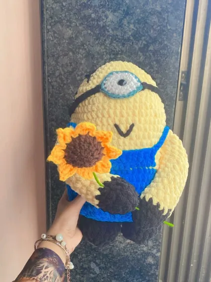 Holding up the finished Minion doll to show its size. Each custom piece is made to your specifications, so you can choose how big or small you want your character to be.