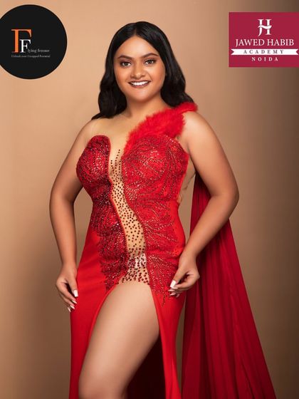 Another angle of the model in the red gown, emphasizing the drama and elegance of the complete look.