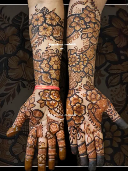 A unique floral design featuring large hibiscus flowers on the arms. The asymmetrical layout and bold execution give this traditional floral mehendi a contemporary edge.