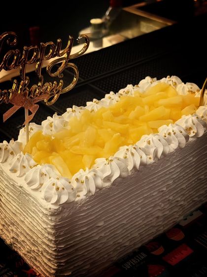 A classic and all time favorite, the fresh pineapple cake. This rectangular loaf cake is topped with chunks of juicy pineapple and surrounded by light, fluffy whipped cream piping.