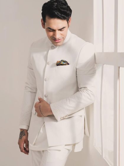 Enjoy the elegance of pastel-themed weddings with this exquisitely crafted white Bandhgala set. It's perfectly tailored for a clean, sophisticated, and celebratory look.