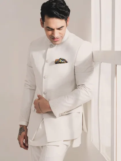 Enjoy the elegance of pastel-themed weddings with this exquisitely crafted white Bandhgala set. It's perfectly tailored for a clean, sophisticated, and celebratory look.