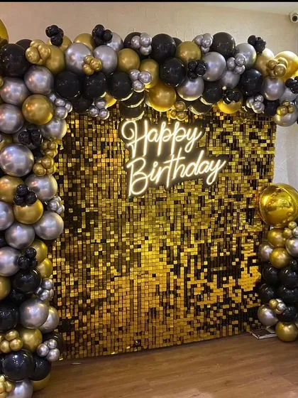 For a stylish and modern celebration, I designed this stunning photo booth with a gold shimmer wall. The setup is framed by a black, gold, and silver balloon arch and lit by a "Happy Birthday" neon sign, perfect for milestone birthdays and elegant parties.