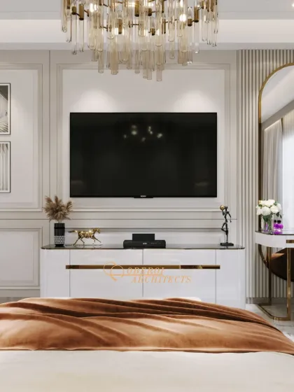 The media wall in this bedroom is a statement piece, featuring a large TV, a stunning chandelier, and a sleek white console with gold trim.