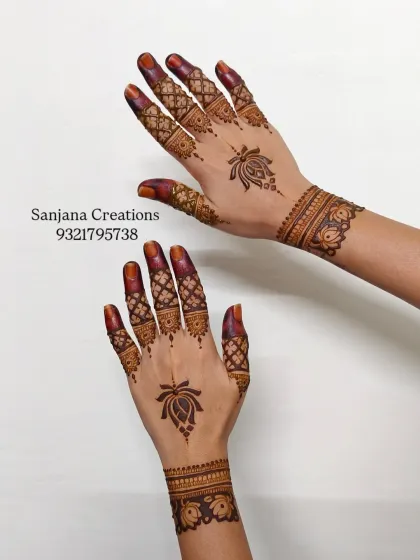 This Pinterest-worthy design is all about clean lines and aesthetic appeal. A single lotus motif on the back of the hand is paired with intricate finger details and a simple cuff.