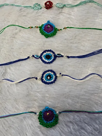 A collection of my evil eye and peacock feather rakhis. These are not just threads, but handmade hugs to protect your loved ones.