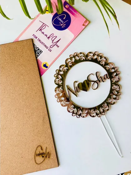 A beautiful "Ni-Sha" topper with a heart, set within an intricate mandala-style frame for a unique and artistic look.