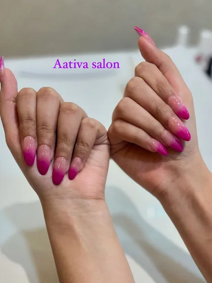 Go bold with a vibrant pink ombré. These long stiletto nails feature a dramatic fade from a sheer base to a bright, hot pink tip.