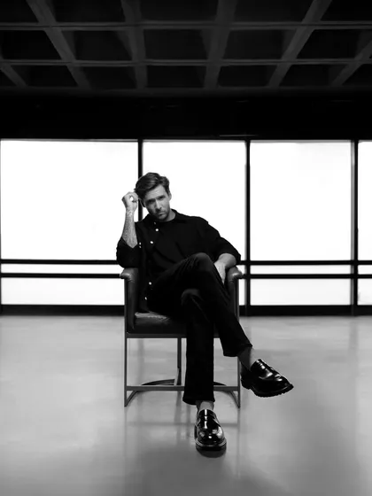 A moody black and white portrait for a Moral Code campaign. The minimalist setting and dramatic lighting create a sophisticated and high-end feel for the brand.