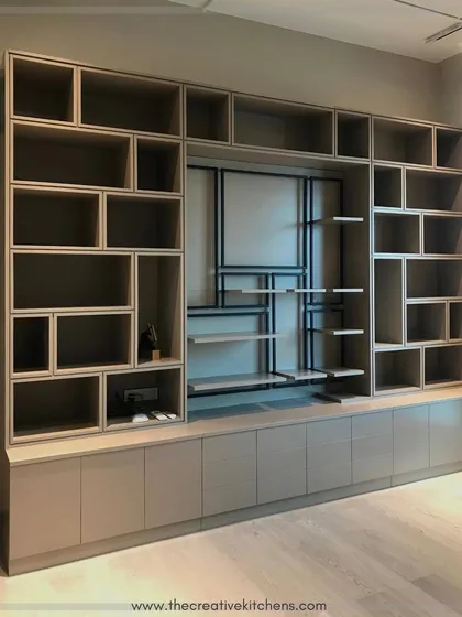 For the avid collector, we design expansive library units that are both functional and visually stunning. This wall-to-wall library, finished in a sophisticated PU, features an array of asymmetrical shelves to display books and artifacts of all sizes.