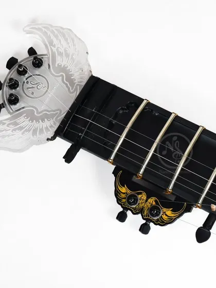 This photo shows the custom winged headstock along with other decorative elements on the electric sitar.