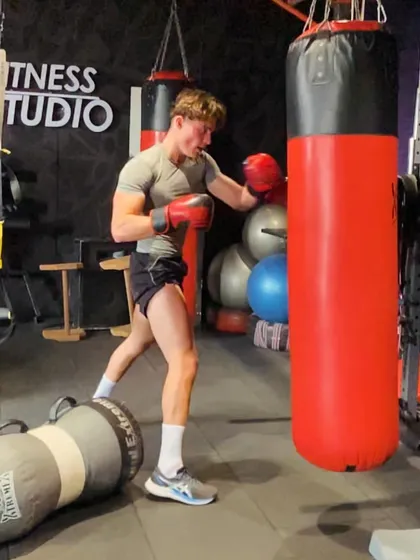 A moment of intense focus during a heavy bag workout. This type of training is fantastic for building punching power, improving coordination, and serves as an incredible outlet for stress.