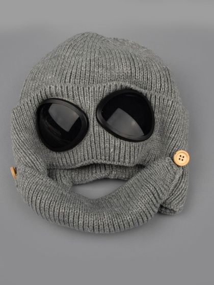 A grey knitted winter balaclava with built-in goggles.