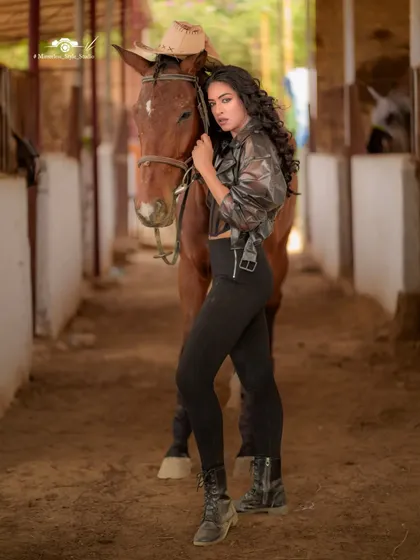 This shot inside our stables showcases a different aesthetic. The rustic wooden structure and earthy tones create a moody and intimate setting for portrait and fashion photography.