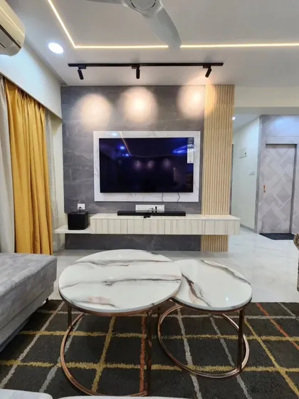 A close-up of the nested coffee tables with marble tops and rose gold frames, adding a touch of elegance to the living room.