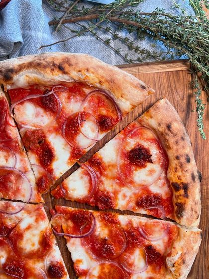 New on the menu: our Goan Sausage Pizza! We're turning up the heat with this flavourful creation.