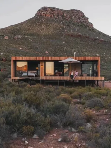 A beautiful example of our wood-clad modular home, designed to harmonize with its natural surroundings. The expansive deck and large sliding glass doors create a perfect indoor-outdoor living experience.