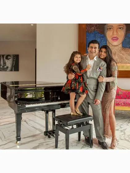 A warm family portrait of a father and his daughters at their home, centered around their piano. Shooting in a client's personal space allows me to create images that are both elegant and deeply personal.