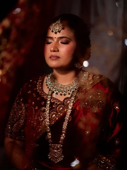 A peaceful and artistic shot of the bride. The soft lighting and her serene expression create a beautiful, timeless portrait.