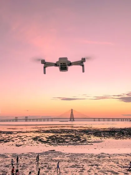 My DJI drone captured in mid-air against the backdrop of the sunset over the Mumbai coast and the Sea Link.