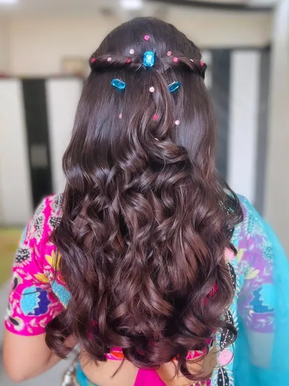 The back view of the boho hairstyle, showing the braided detail and colorful accessories.
