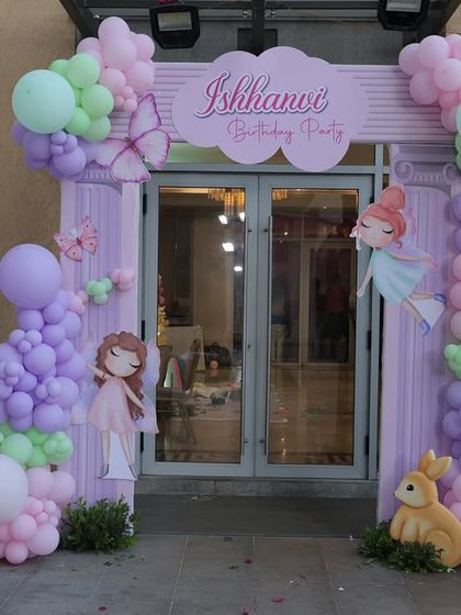 The entrance to Ishhanvi's bunny-themed first birthday party. The pastel balloon arch, custom signage, and a photo board celebrating her first year created a personal and inviting welcome.