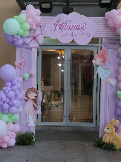 The entrance to Ishhanvi's bunny-themed first birthday party. The pastel balloon arch, custom signage, and a photo board celebrating her first year created a personal and inviting welcome.
