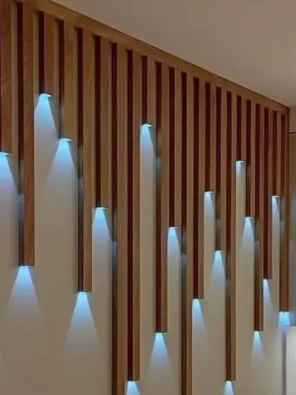 An creative wall installation using wooden slats with integrated lights, creating a dynamic and artistic lighting effect.