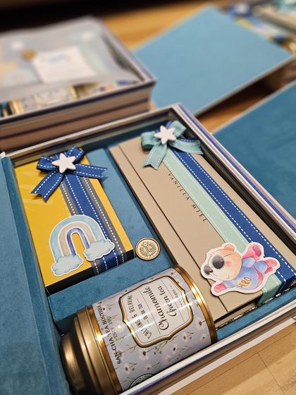 A closer look inside one of my signature book boxes. You can see how each item is carefully wrapped and placed, with details like custom ribbons and a personalized wax seal making it a true statement piece.
