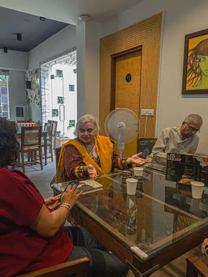 A lively conversation happening at one of our tables, surrounded by books. This is a common sight here, where stories often spill over into real-life connections.