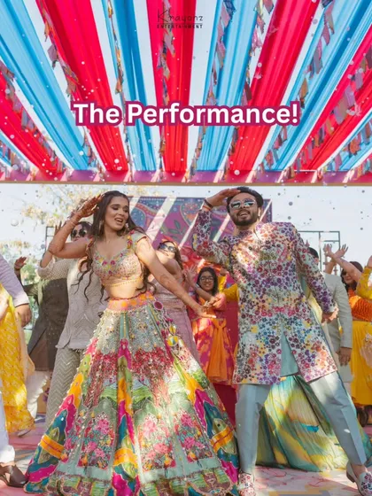 The couple's energetic performance at their wedding carnival. Their coordinated outfits and joyful expressions show they are having the time of their lives.