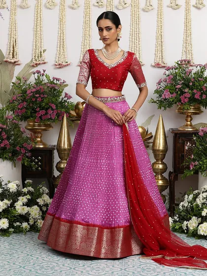 The full look, showing the beautiful contrast between the pink lehenga and the red blouse and dupatta.