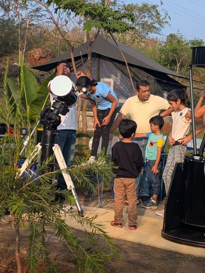 Families gather around the telescopes as dusk settles in. The excitement builds as we prepare for a night of looking up at the planets and stars.