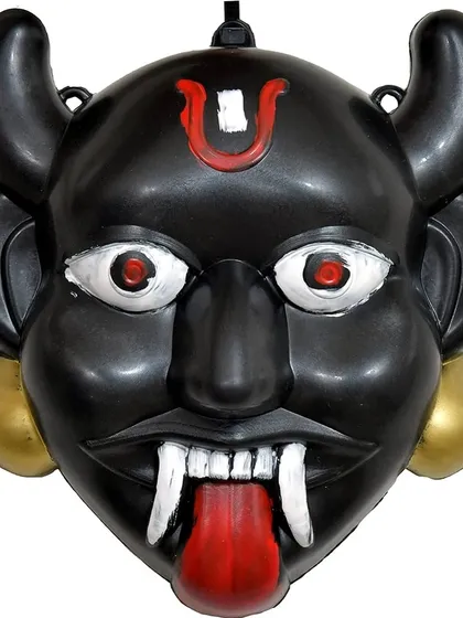 A close-up of the 'Nazar-Bottu', a traditional Indian charm to ward off the evil eye, updated as a functional robot. The eyes glow and the tongue is a scanner.