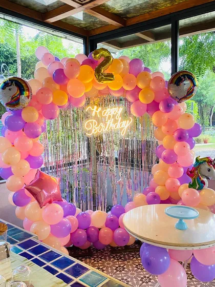 Another angle of the unicorn party, showing the silver shimmer curtain and unicorn foil balloons.