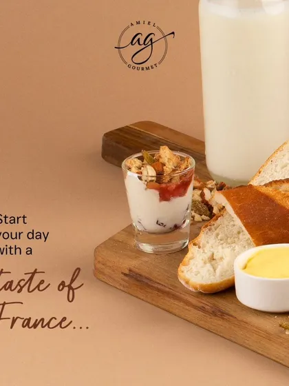 Start your day with a taste of France. My breakfast spread includes freshly baked bread with butter and jam, a small yogurt parfait with granola, and other little treats to make your morning special.