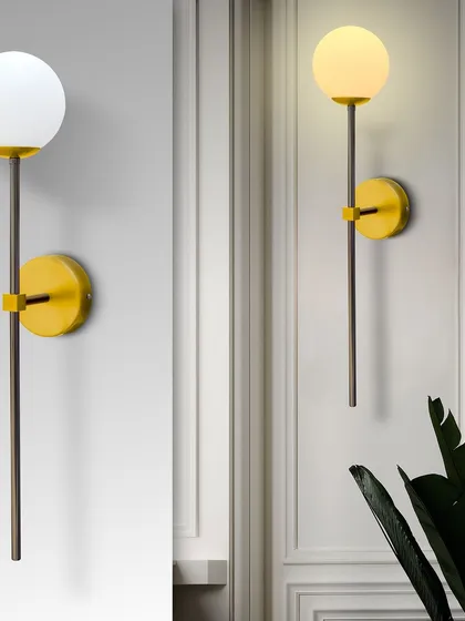 The globe wall sconce is shown here in both its off and on state. The yellow base adds a pop of color, making it a fun and stylish choice.
