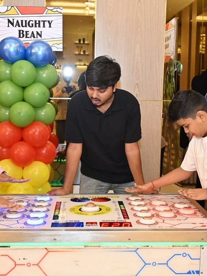 Kids of different ages enjoying the arcade-style games together. I plan activities that encourage interaction and friendly competition.