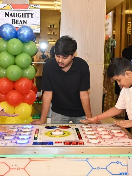 Kids of different ages enjoying the arcade-style games together. I plan activities that encourage interaction and friendly competition.