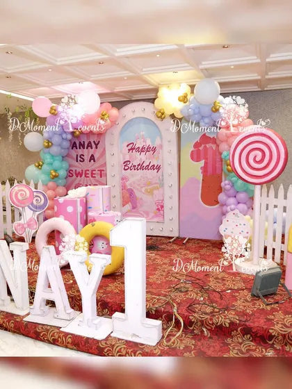 A detailed shot of the Candyland stage, showing the variety of props including ice cream cones, candy pieces, and a white picket fence, all contributing to the whimsical theme.