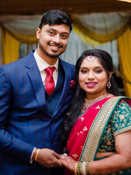 A happy couple at their reception. Her makeup is designed for the evening, with a slightly bolder lip and eye to stand out in photos and match the celebratory mood.